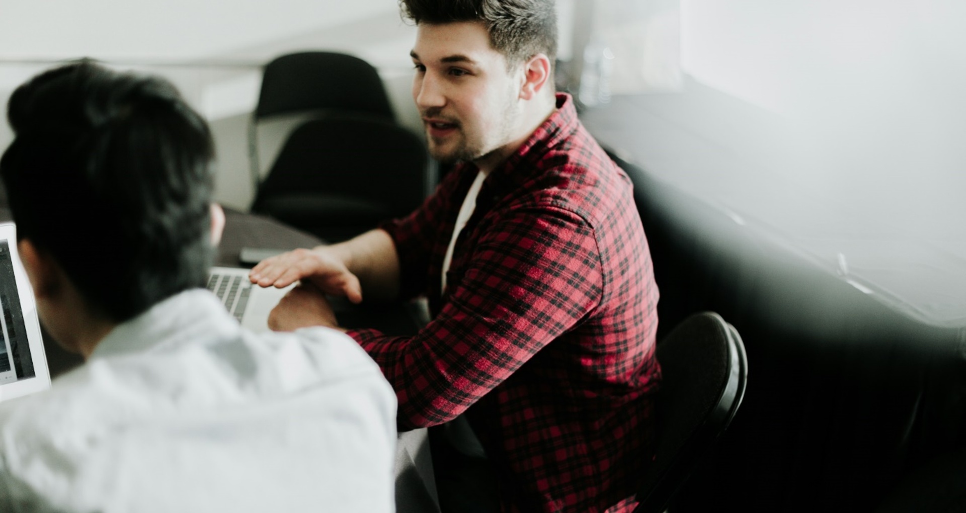 Two men having a conversation sitting at a table