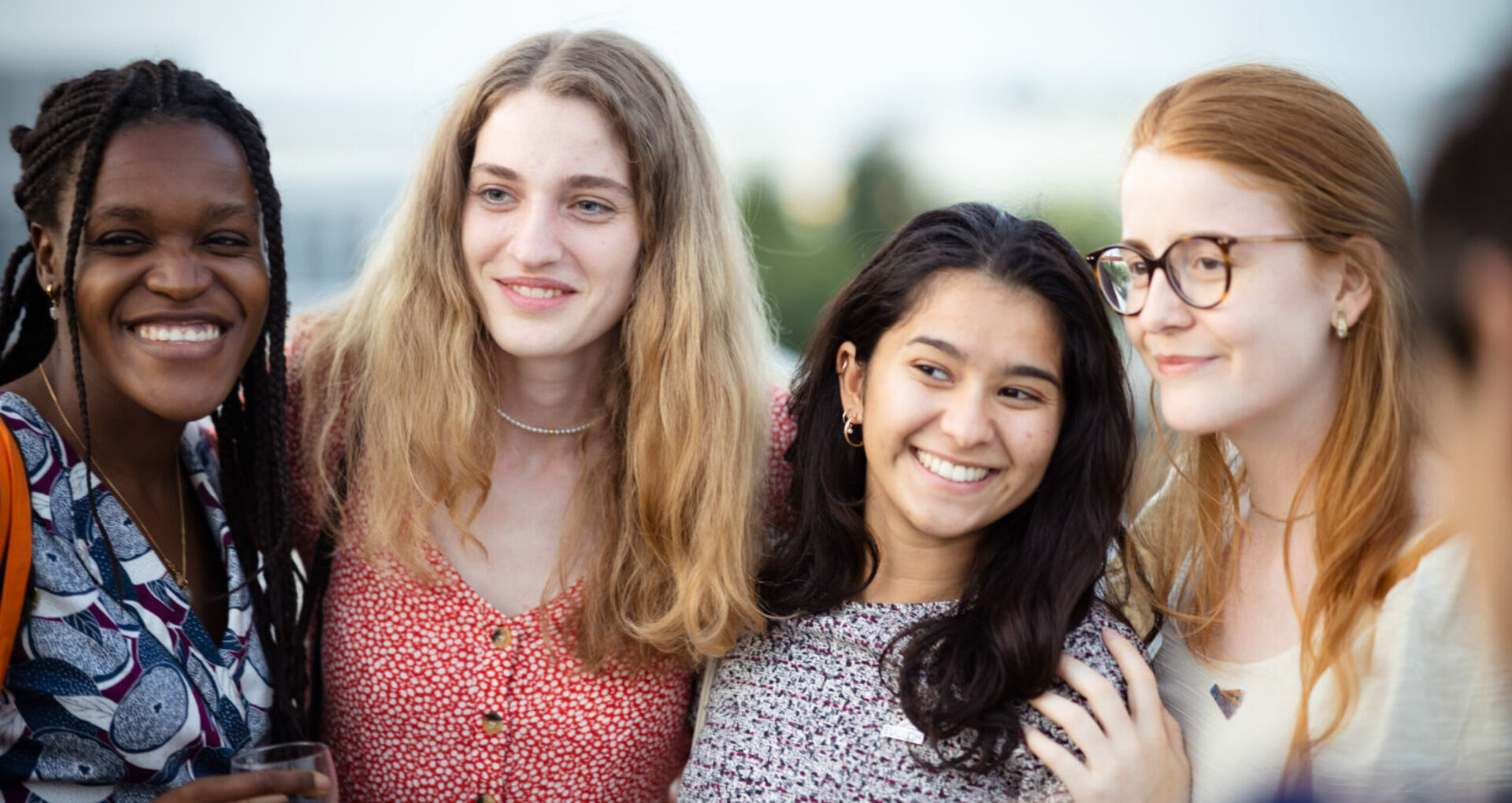 Four students smiling at the 2022 Annual Summit in Paris-Saclay.